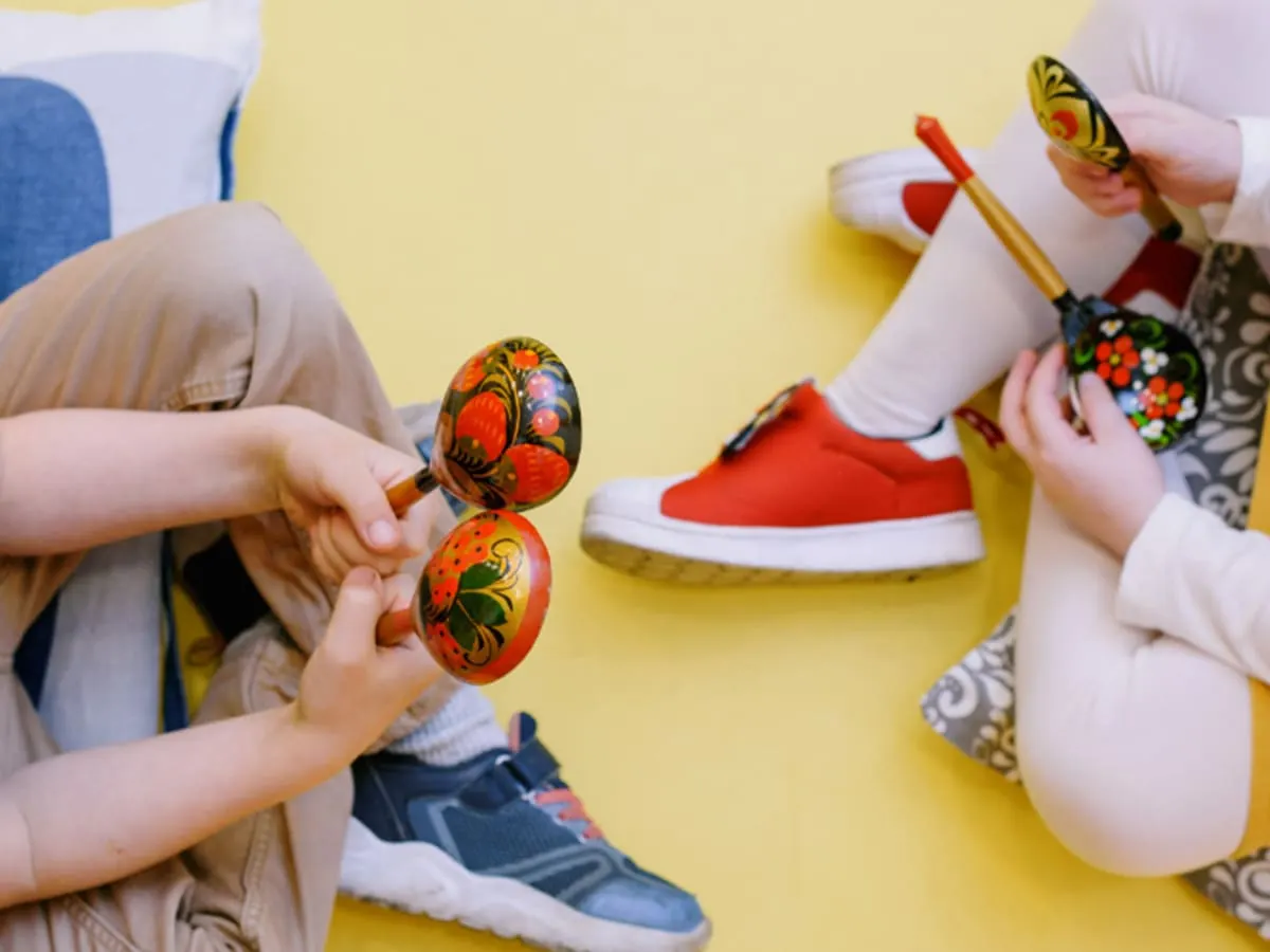 Photo de deux enfants assis avec des maracas